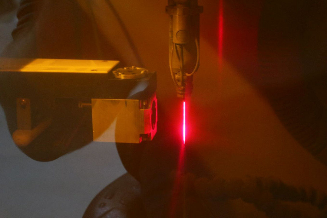 Die Qualität der Düsenöffnung wird indirekt durch Analyse der Raman-Strahlung erfasst; links der Sensor, rechts der durch das Laserschutzfenster rot erscheinende „LMJ“-Strahl. - © Synova